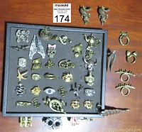 Overview of the main tray holding about 25 assorted novelty rings with gothic and fantasy motifs