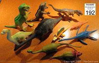 Top view showing all vintage dinosaur figures arranged on orange surface.