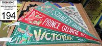 Four vintage British Columbia pennants including Stanley Park, Prince George, Victoria, Totems, displayed flat on a table with clear text and illustrations.