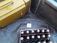 One six-pack of vintage Coca-Cola glass bottles with red caps in cardboard carrier