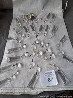 Overview photo showing most of the glass crystal prisms arranged around the metal base on fabric.