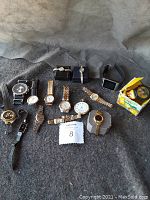 Overview of all watches and pocket watch on gray felt
