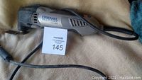 Photo of Dremel Multi-Max MM30 tool with cord and blade attachment.