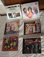 Photo showing six opera CDs including Verdi by Richard Margison, Puccini Tosca, EMI Opera Fare sets 6 and 7, Great Moment of Opera box set, and Opera Fare 4 box set.