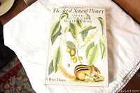 Front cover of the book showing detailed natural history illustration featuring a chipmunk and botanical elements.