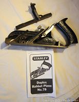 Stanley No. 78 Duplex Rabbet Plane with fillister attachment and manual laid flat on a surface, showing overall tool design and condition.