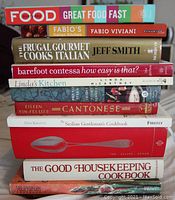 Stack of 12 cookbooks showing varied titles and thicknesses
