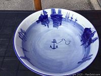 Overhead view of bowl interior showing anchor motif at center and sailboat scenes around rim on white glaze