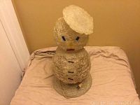 Front view of the vintage mid century snowman lamp made with clear spaghetti-style plastic strands, showing overall shape and base.