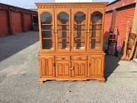 Full front view of the two-piece solid maple buffet and hutch outdoors.