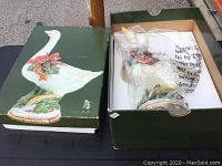 Box with original packaging showing the goose illustration on top and the figurine wrapped inside with protective paper