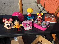 Overview of Mickey and Minnie Mouse items including masks, plush dolls, toys, and folders