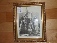 Framed black and white artwork showing historical figures including Don Chase's grandfather on the right side. Ornate gold frame detail visible.