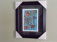 Full view of framed print hanging on wall with protective cardboard corners