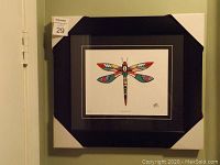 Framed colorful Indigenous art print by Keith Gattie showing the full frame and artwork with protective corner covers.