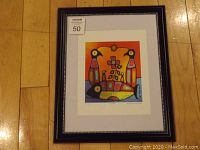 View of framed fine art print showing full artwork, mat, and black frame with beaded detail on hardwood floor.