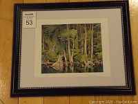 Framed fine art print showing the full artwork and frame with lot number tag.