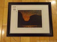 Framed art from a distance showing the overall condition and size, with visible label 55.