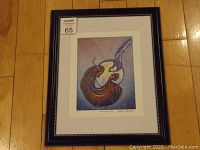 Framed fine art print shown upright on wooden floor, including overall frame and matting, with the print visible inside.