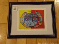 Full view of framed print with dark wood frame and white matting showing Thunderbird Revolution artwork by Norval Morrisseau.