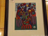 Framed Norval Morrisseau print titled Thunderbird, showing vibrant Indigenous art with blue background and red, yellow, purple, green details