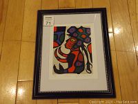 Full view of framed art print titled "Future" by Norval Morrisseau, showing the frame, matting, and colorful Indigenous style imagery.