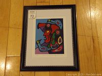 Framed fine art print showing entire image, black frame with silver beads, matting, and colorful indigenous style artwork with birds and human profile.