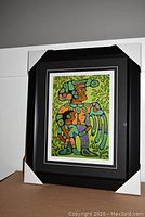 Framed and matted fine art print "Grandfather with Child" showing full frame with corner protectors and mounted on board.