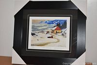 The complete framed item with black frame and white corner protectors.