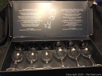 Six wine glasses displayed inside an original One for All box with printed text inside lid.