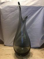 Front view of tall olive green vase with pinched organic rim