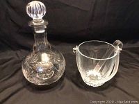 Full view of crystal decanter with medallion and glass ice bucket with tongs
