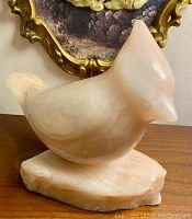 Front angled view showing the smooth carved soapstone cardinal bird and base with subtle natural variations in stone color and texture.
