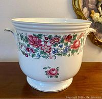 Front view of vintage Crown Staffordshire plant pot showing Thousand Flowers pattern, two small side handles, and gold trim on white ceramic.