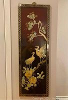 Full front view of the rectangular lacquered wood panel showing entire mother-of-pearl inlay design