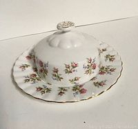 Side angle view of the Royal Albert 'Winsome' butter dish showing the floral pattern and gold trim on the lid and plate.