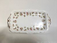 Top view of the rectangular bone china serving tray showing the floral pattern and gold-highlighted handles.