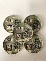 Five vintage Johnson Bros. Christmas plates arranged in a cluster, showing the front festive design with a fireplace, Christmas tree, and presents.