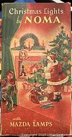 Vintage NOMA Christmas Lights packaging illustration with Santa Claus by fireplace and children