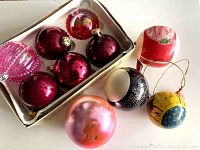 Photo showing 7 purple and multicolored vintage Christmas ornaments with various finishes and designs
