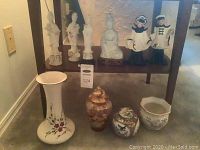 Group photo showing all porcelain items on lower and upper shelf including figurines, vases, jars, and a pitcher