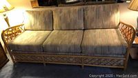 Full front view of the 3 seat sofa showing the bamboo style frame and cushion upholstery