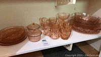 Overview of all items on shelf: plates, bowls, tumblers, sugar bowl, sherbets