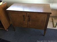 Front and side view of the wooden vintage LP cabinet showing overall condition and design.