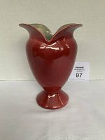 Front and side view of Red Wing Pottery vintage vase with rich red exterior and pedestal base.