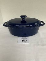 Blue enamel cast iron oval pot with lid, front view showing the pot closed with lid.