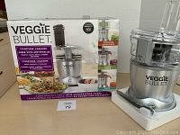 Photo of Veggie Bullet spiralizer with box displaying product and functions
