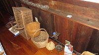Overview of four woven baskets and additional items on wooden shelf