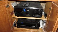 Sony CD changer and Onkyo receiver in wooden cabinet