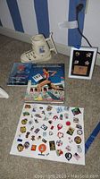Full view of the Olympic pins collection, Pin Collectors Guide book, ski boot mug and commemorative pin set in frame.